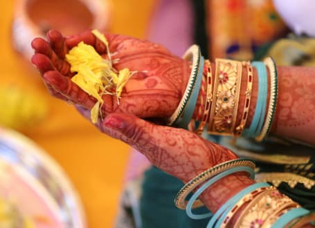Traditional Hindu puja ceremony with diyas and offerings